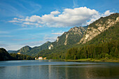 View over Alpsee to Neuschwanstein castle and Tegelberg and Saeuling, near Hohenschwangau, Fuessen, Allgaeu, Bavaria, Germany