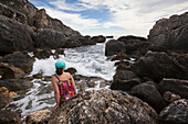 Woman at the rocky coast near Agios Georgios, Corfu island, Ionian islands, Greece
