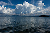 Cumulus clouds above lake Lago di Bolsena, Isola Martana im Hintergrund, crater lake of volcanic origin, near Montefiascone, province of Viterbo, Lazio, Italy, Europe