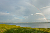 Rainbow seen from the lake shore of lake Castiglione del Lago, Lago Trasimeno, province of Perugia, Umbria, Italy, Europe
