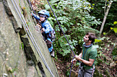 Boy (4 years) climbing at a rock, Gaudlitzberg stone pit, Roecknitz, Thallwitz, Saxony, Germany