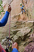 Boy (3 years) climbing on a rock, stone pit Aktienbruch, Loebejuen, Saxony-Anhalt, Germany