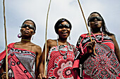 Three young Swazi women in traditional clothes wearing sunglases, Swaziland, Africa