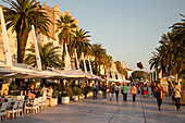 People sitting in outdoor cafes along The Riva seafront promenade, Split, Split-Dalmatia, Croatia