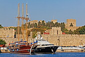 Schiffe im Emboriohafen, dahinter die Stadtmauer der Altstadt, Rhodos Stadt, Rhodos, Dodekanes, Südliche Ägäis, Griechenland