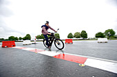 Man riding an electric bicycle on a test track, Tanna, Thuringia, Germany