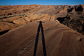 Shadow of a photographer on red rocks near Moab, Utah Moab, Utah, USA