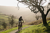 A man rides his mountain bike through the English countryside England
