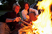 A couple enjoy a campfire in Everglades National Park, Florida Florida, USA