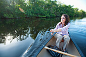 A woman paddles a canoe in Everglades National Park, Florida Florida, USA