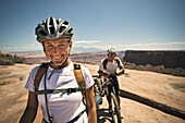 Portrait of a female mountain biker in her helmet, smiling at the camera in Utah Moab, Utah, USA