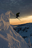 Skier jumping in mid-air at sunset in Canada Revelstoke, British Colombia, Canada