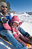 Father and daughter sledding in Durango, Colorado Durango, Colorado, USA