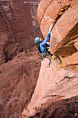 A woman rock climber in the Fisher Towers, Utah Moab, Utah, USA