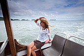 A woman in a cowboy hat relaxes on a boat in Brazil Brazil