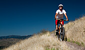 A male mountain biker pedals the trail on Mt. Sentinel, Missoula, Montana Missoula, Montana, USA