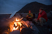 Two men sit around a camp fire on The Lost Coast, California Shelter Cove, California, USA