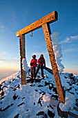 Two people are framed by a wooden gate on Mount Fuji, Honshu, Japan Honshu, Japan