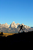 A man hikes his bike in the Gros Ventre Range in Wyoming Jackson, Wyoming, USA