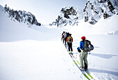 A group of skiers in the backcountry on a clear day Washington, USA