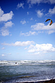 Kitesurfer rides the waves on a sunny day with a few clouds in the sky Cardiff-by-the-sea, California, USA