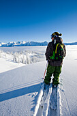 Man traversing on skis, BC, Canada Monashee Mountains, British Columbia, Canada