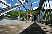 Woman runs across a steel bridge Fayetteville, West Virginia, USA