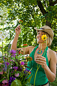 A young woman picks out flowers at a Farmer's Market Sandpoint, ID, USA