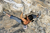 A rock climber ascends a steep rock face in Mexico El Potrero Chico, Nuevo Leon, Mexico