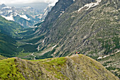 A group of hikers assemble on a lookout point, high above a deep valley Mont Blanc, France