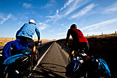 Two male cyclists ride Highway 65 outside of Porterville, California Porterville, California, United States of America