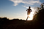 A woman  trail running on the crest trail. Big Cottonwood Canyon, Utah, Utah, USA