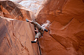 A man rock climbing outside of Moab, Utah Utah, USA