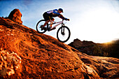 A middle age man rides his mountain bike through the red rock country around Sedona, Az at sunset Sedona, AZ, USA