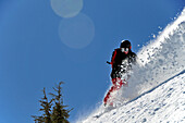 A male snowboarder makes a big powder turn in the Kirkwood backcountry, CA Kirkwood, California, USA