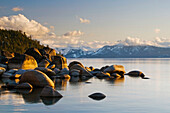 Golden afternoon light illuminates granite boulders on the east shore of Lake Tahoe, NV Lake Tahoe, Nevada, USA