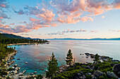 Beautiful clouds are illuminated at sunset over Sand Harbor and Lake Tahoe, Nevada Lake Tahoe, Nevada, USA