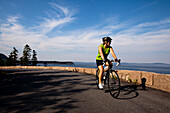 A female cyclist rides her road bike in Maine's Acadia National Park Acadia National Park, Maine, United States of America