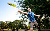 Closeup of a man making a backhanded drive playing disc golf. (Motion Blur), Birmingham, Alabama, United States