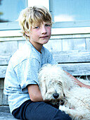 boy and his dog pose for a picture, maine, usa