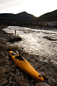A whitewater kayak rests on the shore after a surf session in Ledge Rapid on the Salt River, AZ AZ, USA