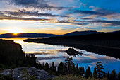 A magnificent sunrise over Emerald Bay with clouds reflecting in the calm water in Lake Tahoe, CA Lake Tahoe, California, USA