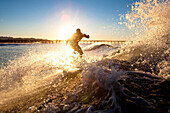 A surfer sets up for an air while riding a wave at Port Hueneme Beach in the city of Port Hueneme, California on December 22, 2007 Hueneme, California, Unites States of America