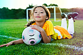 A young girl posing with her soccer ball on a soccer field in Los Angeles, California Los Angeles, California, USA