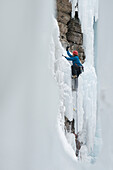 Man climbing ice in the Ouray Ice Park, Ouray, Colorado Ouray, Colorado, USA