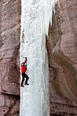 Man climbing ice pillar without a rope, Redstone, Colorado Redstone, Colorado, USA