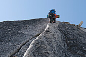 Man rock climbing granite crack, Bugaboo Provincial Park, Radium, British Columbia, Canada Radium, British Columbia, Canada