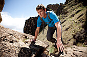 Male scrambling and hiking rocky trail Bend, Oregon, United States