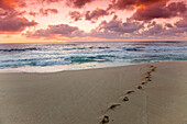 A red sky sunset over Sunset beach in Hawaii north shore of Oahu, Hawaii, USA