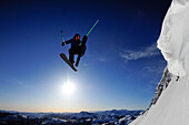 A skier soars through the air at sunrise in the Sierra Nevada mountains near Lake Tahoe, California Carson Pass, California, USA